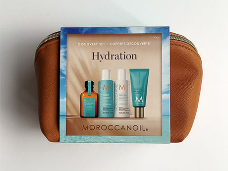 A Moroccanoil hydration product set on a cosmetic bag.