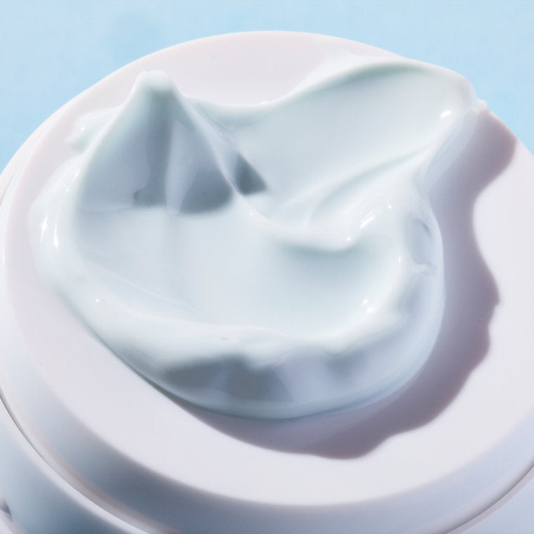 Close-up of Full Spectrum 360º Water Cream, organic face sunscreen SPF 50, showcasing its creamy texture and hydrating properties.