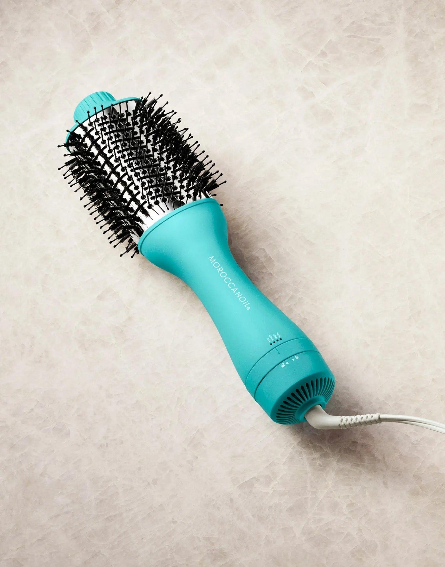 4-in-1 blow-dryer brush in turquoise offering smoother hair, less frizz, and salon-quality styling with minimized hair damage.