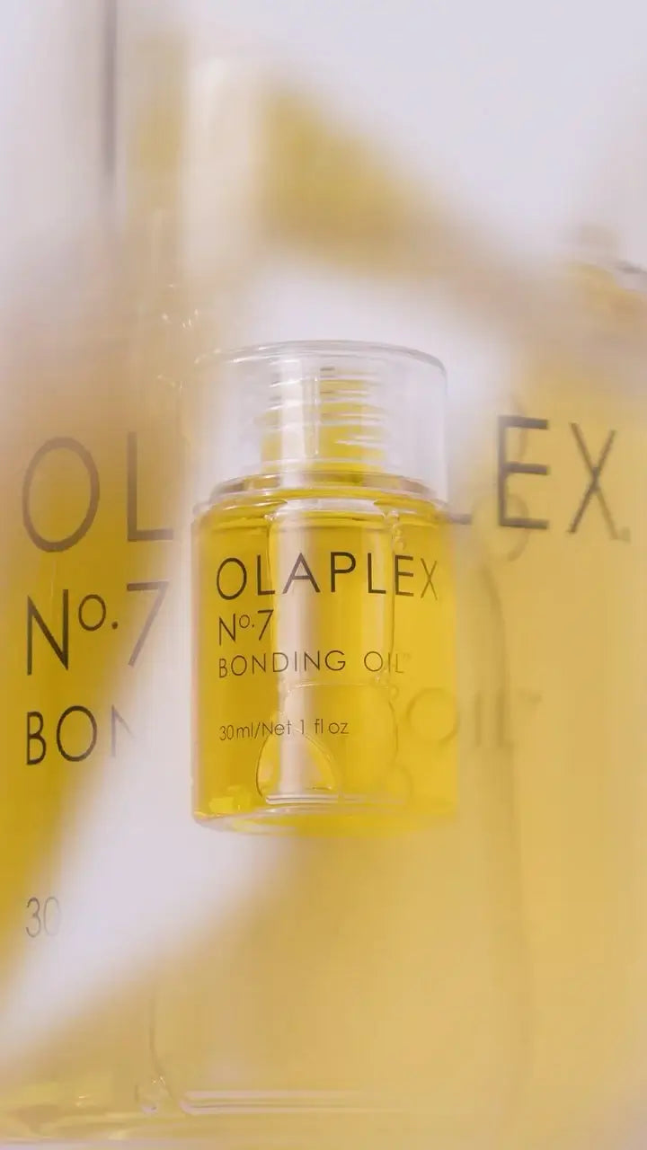 Olaplex No. 7 Bonding Oil bottle close-up showcasing product label and golden liquid detail.