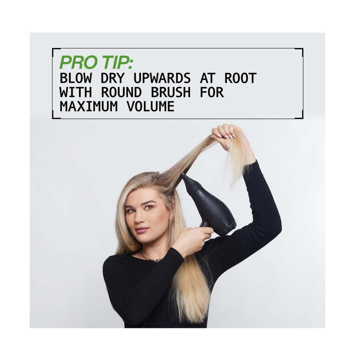 Woman blow drying hair with round brush for maximum volume, pro tip displayed.