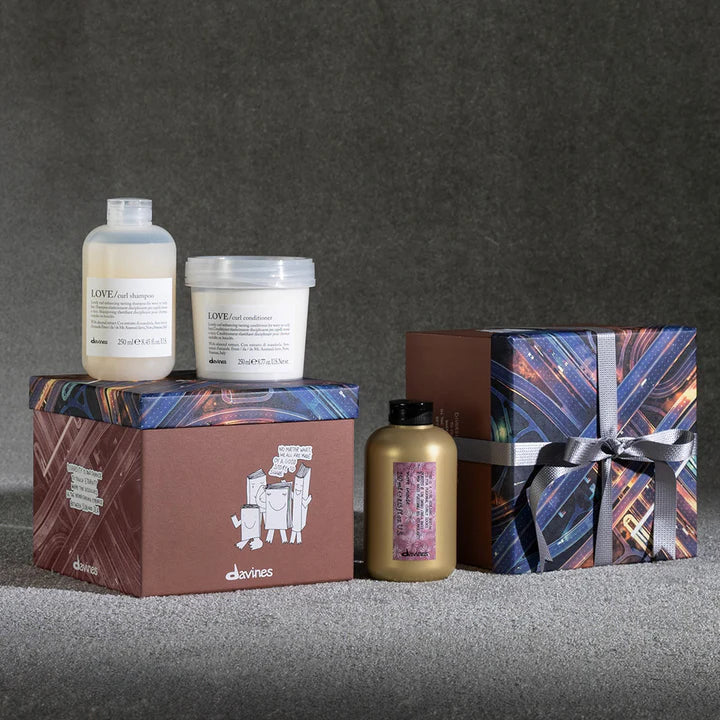 Davines Love Curl More Inside Gift Set with shampoo, conditioner, and serum for enhancing curly hair, displayed with decorative packaging.