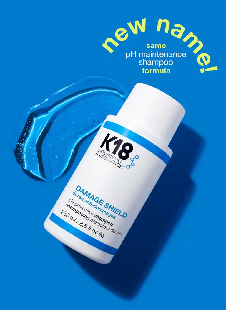K18 DAMAGE SHIELD pH Protective Shampoo bottle on blue background with text 'new name, same pH maintenance formula'.
