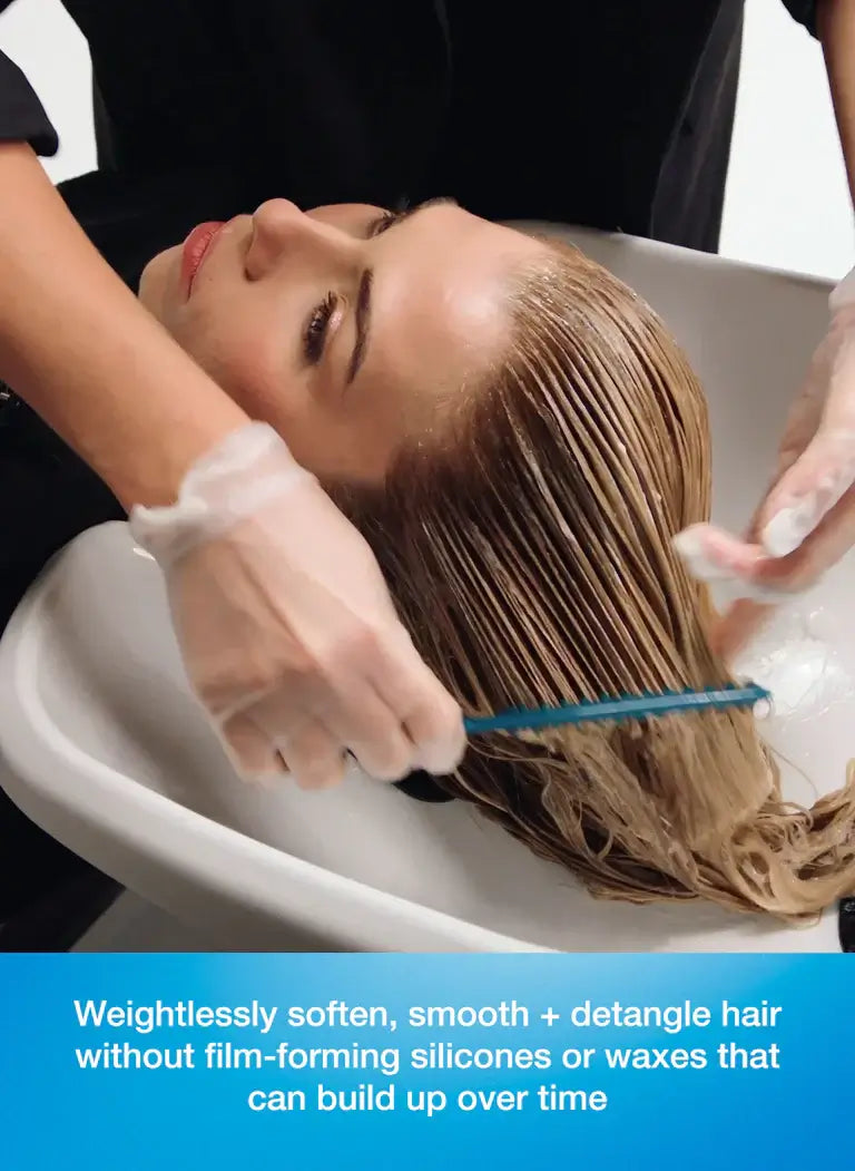 Hair treatment in salon, highlighting DAMAGE SHIELD Protective Conditioner benefits for softness, smoothness, and damage protection.