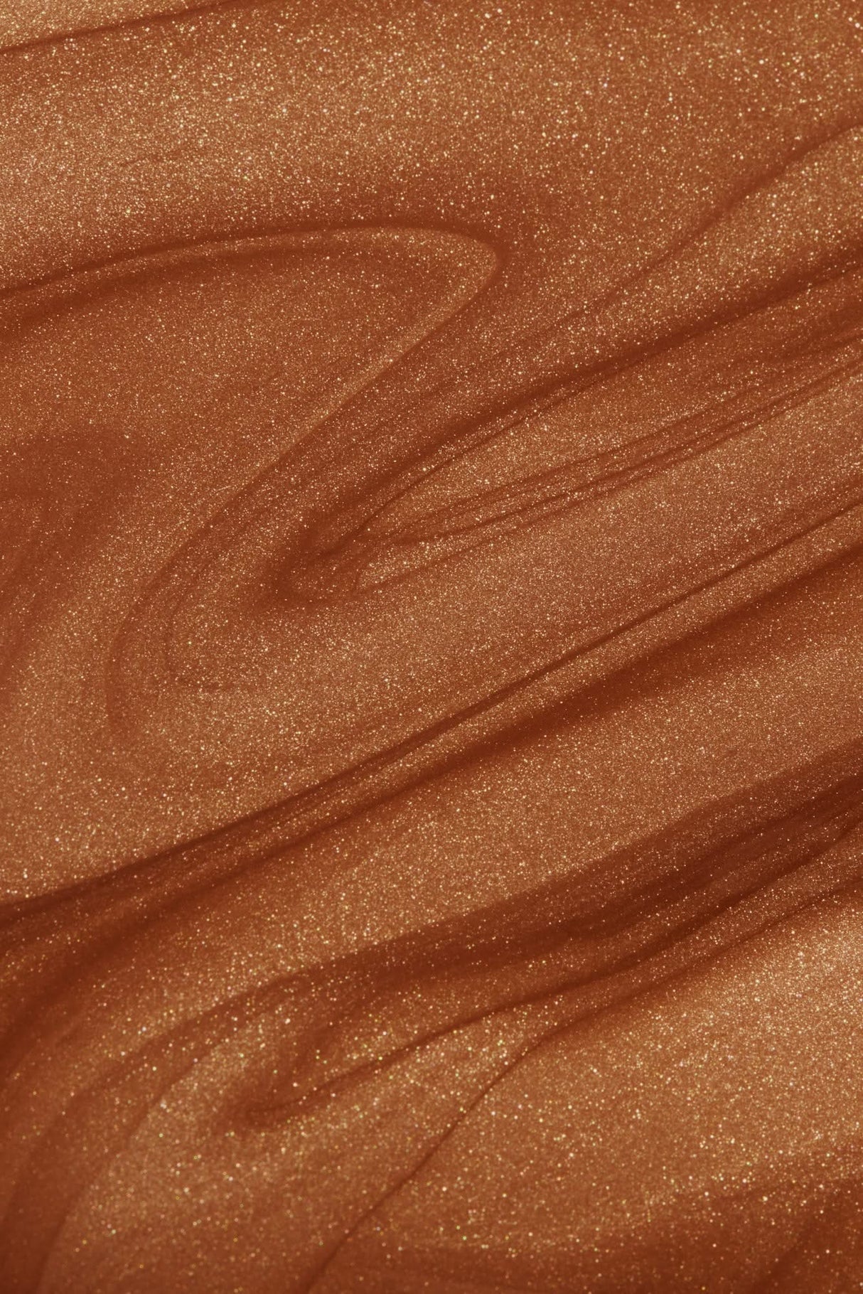 Close-up view of shimmering bronzing glow liquid texture, showcasing smooth, radiant swirls of copper bronze for beauty enhancement.