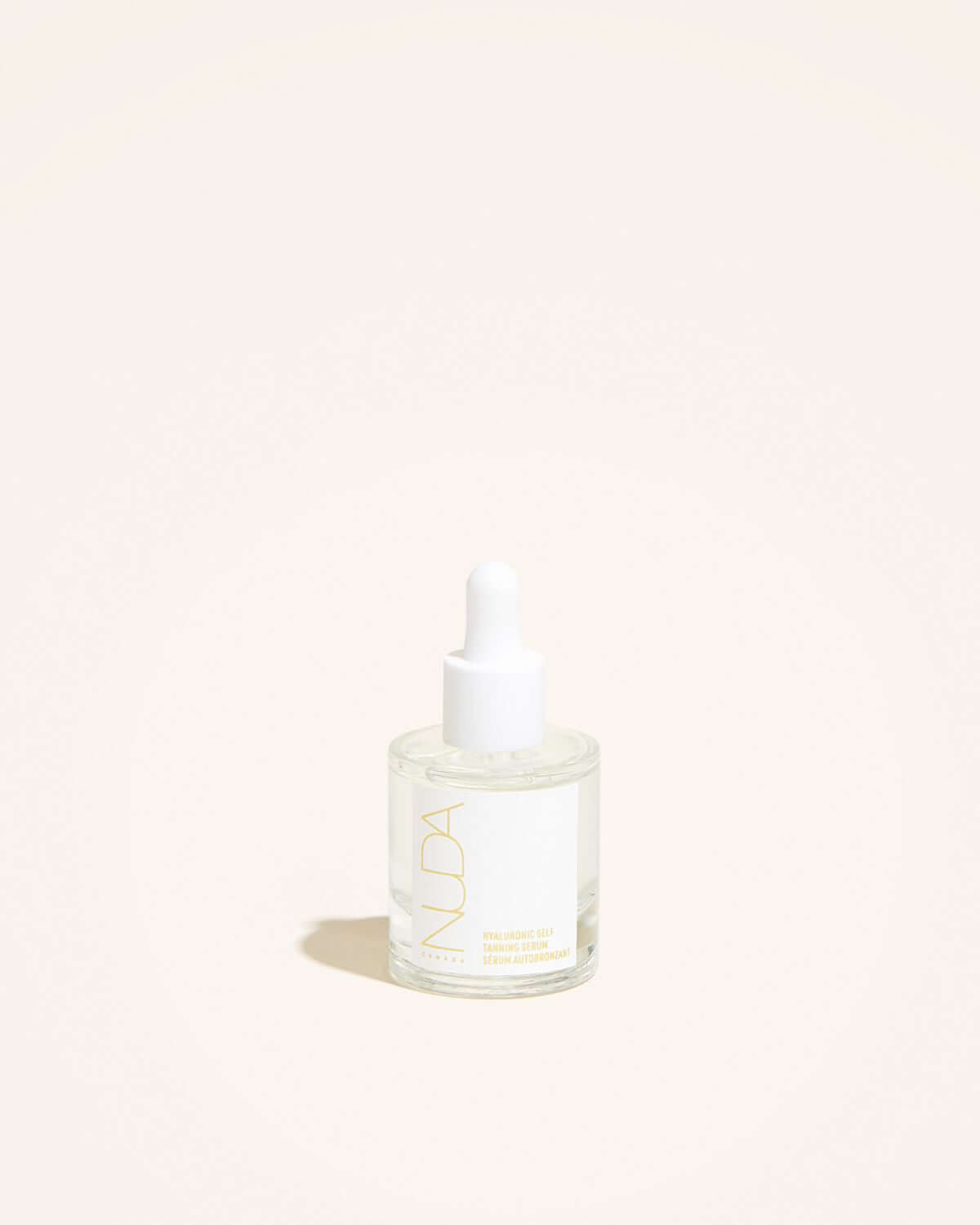 Hyaluronic Self Tanning Serum bottle with dropper on a light background.