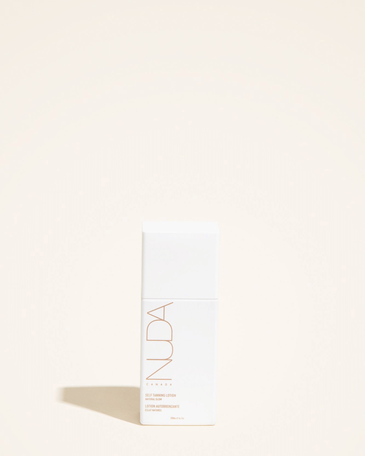 Self tanning lotion bottle on a beige background, promising hydration and a lasting radiant glow for light to medium skin tones.