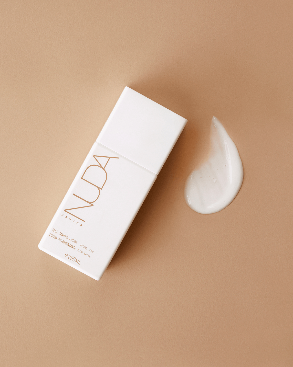Luxurious self-tanning lotion providing a natural glow and hydration, shown with creamy texture on light brown background.