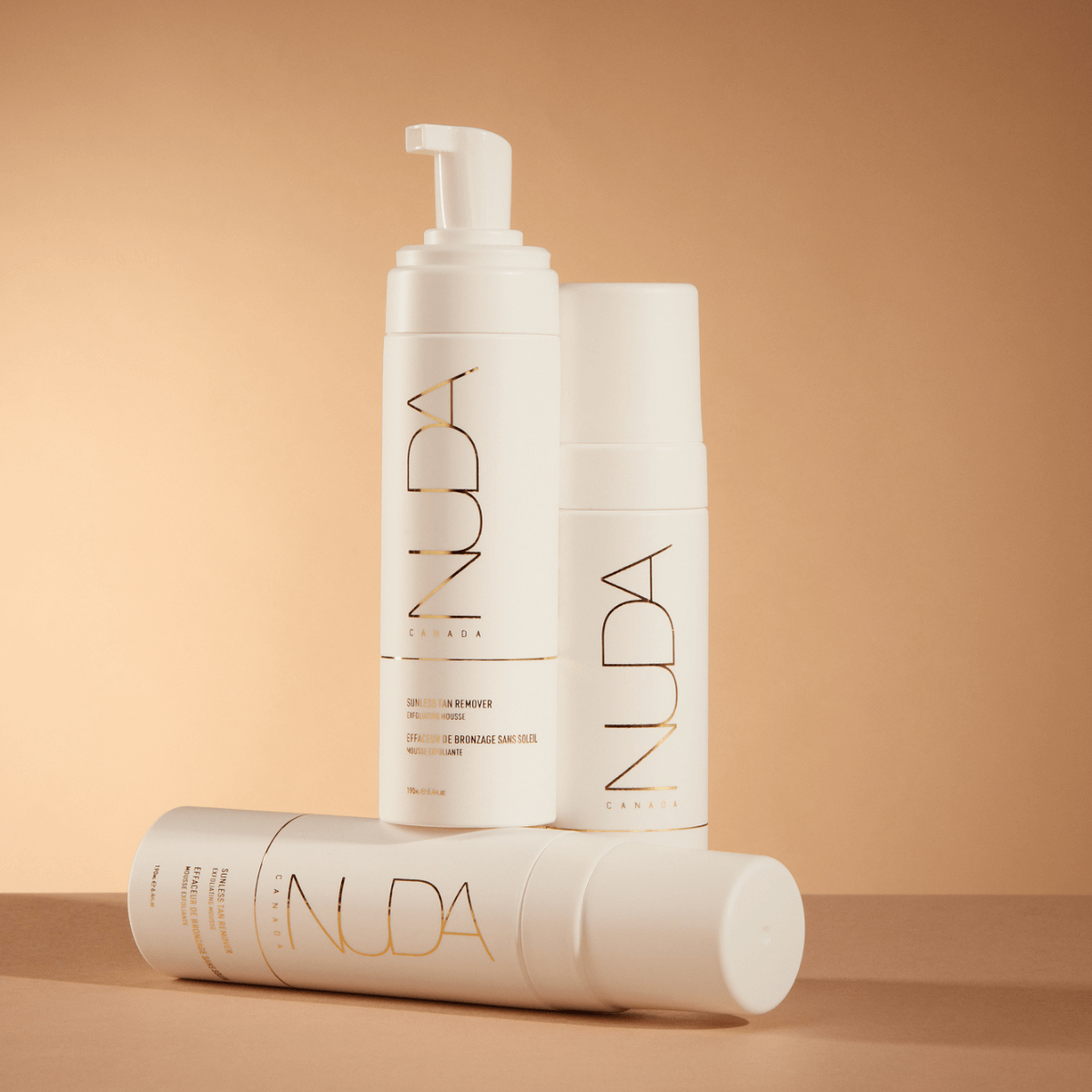 Sunless Tan Remover bottles with gentle exfoliating mousse, featuring aloe vera and grapefruit seed extract for refreshed skin.