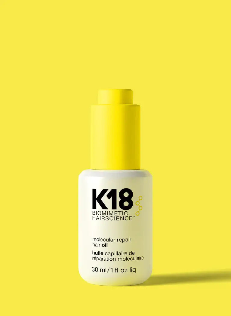 Molecular Repair Hair Oil bottle on yellow background, biotech-engineered for frizz control, shine enhancement, and split end reduction.