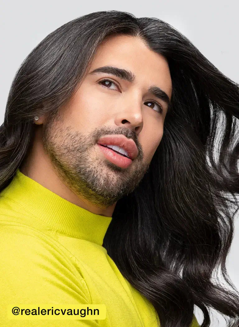 Person with long, flowing hair showcasing shine and smoothness, wearing a yellow top.