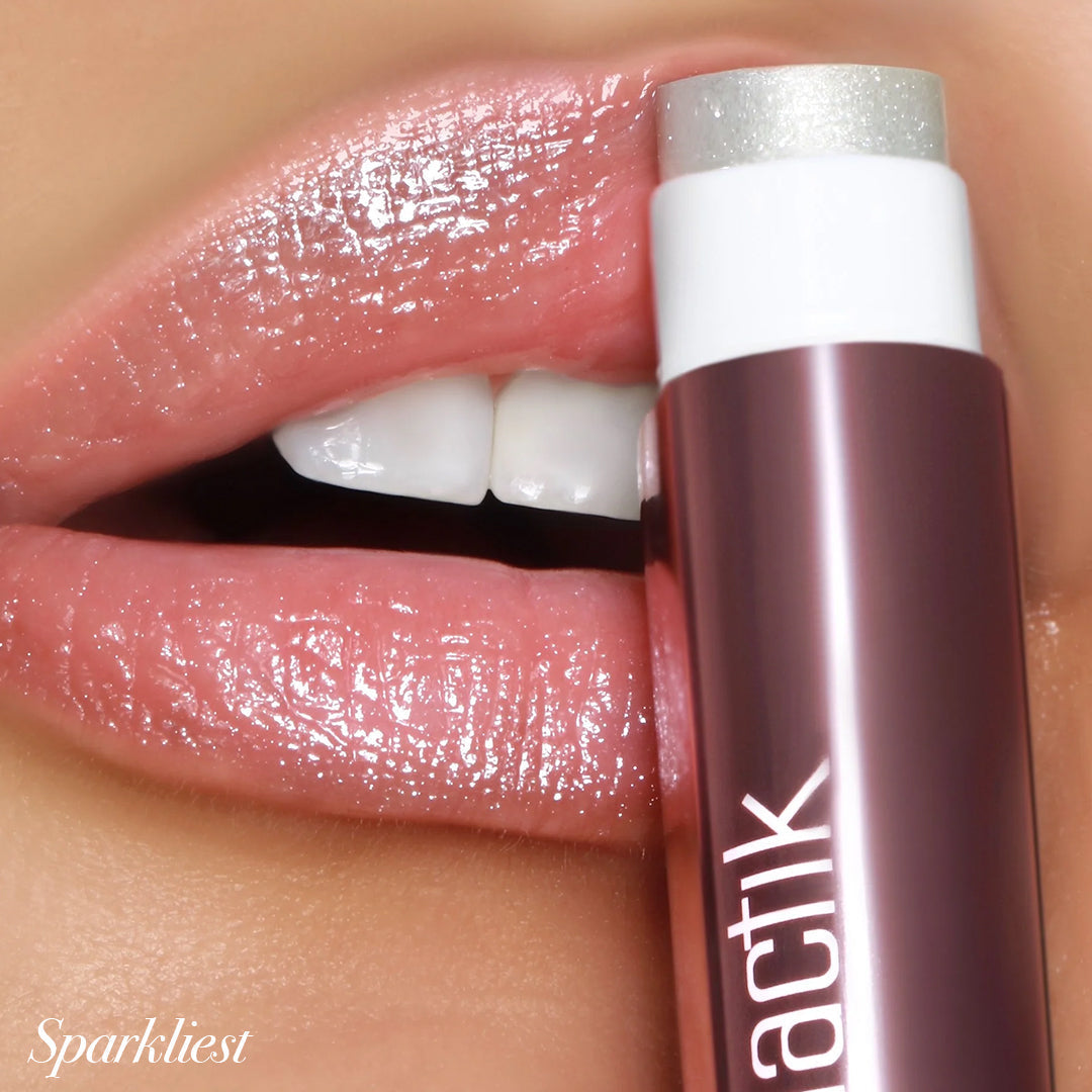 Close-up of lips wearing Girlactik Jello Gloss Balm in Sparkliest, showcasing a glossy, non-sticky finish with pink lemonade scent.