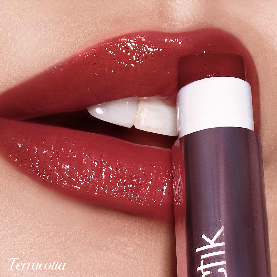 Close-up of lips wearing Girlactik Jello Gloss Balm in Terracotta shade, showcasing a glossy, hydrating finish with nourishing benefits.