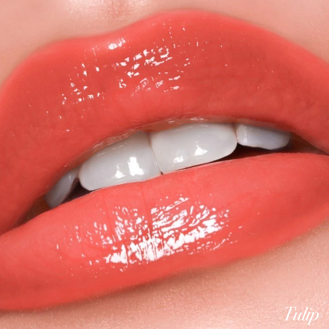 Close-up of lips wearing Girlactik Jello Gloss Balm in Tulip shade, showcasing glossy, moisturizing non-sticky finish.
