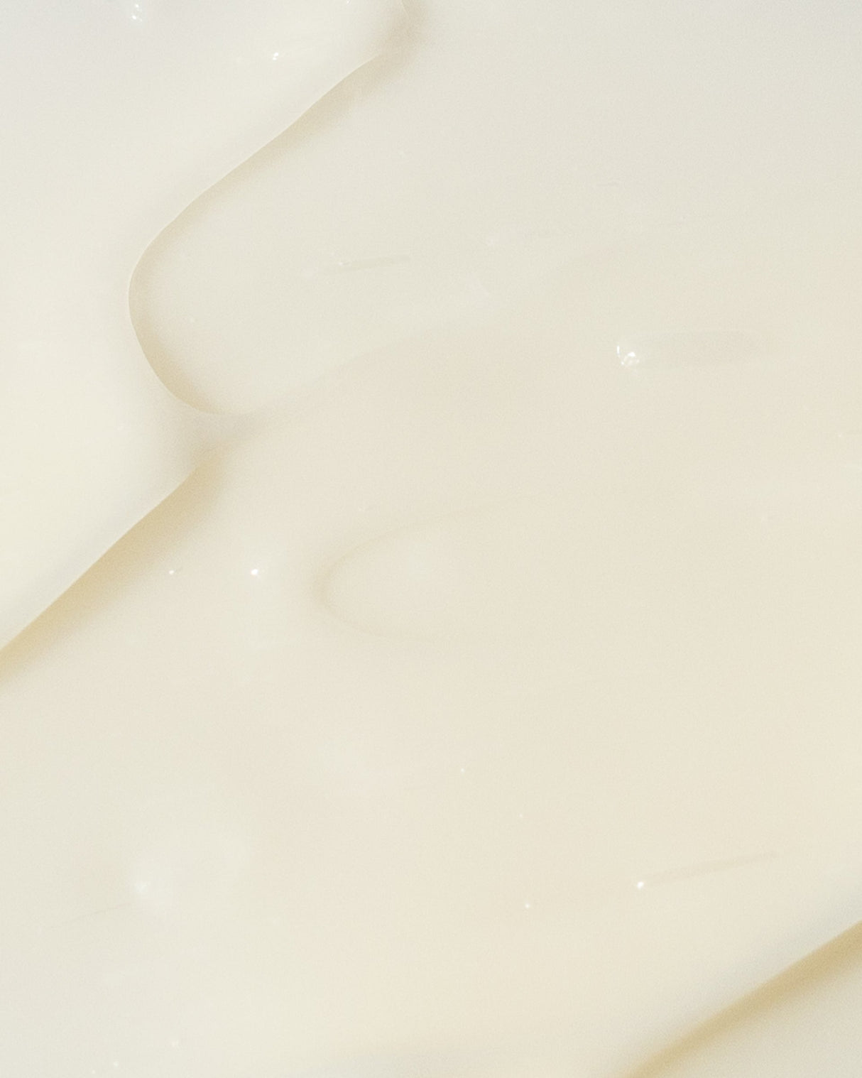 Close-up texture of AHA/BHA exfoliating cream with smooth, creamy consistency.