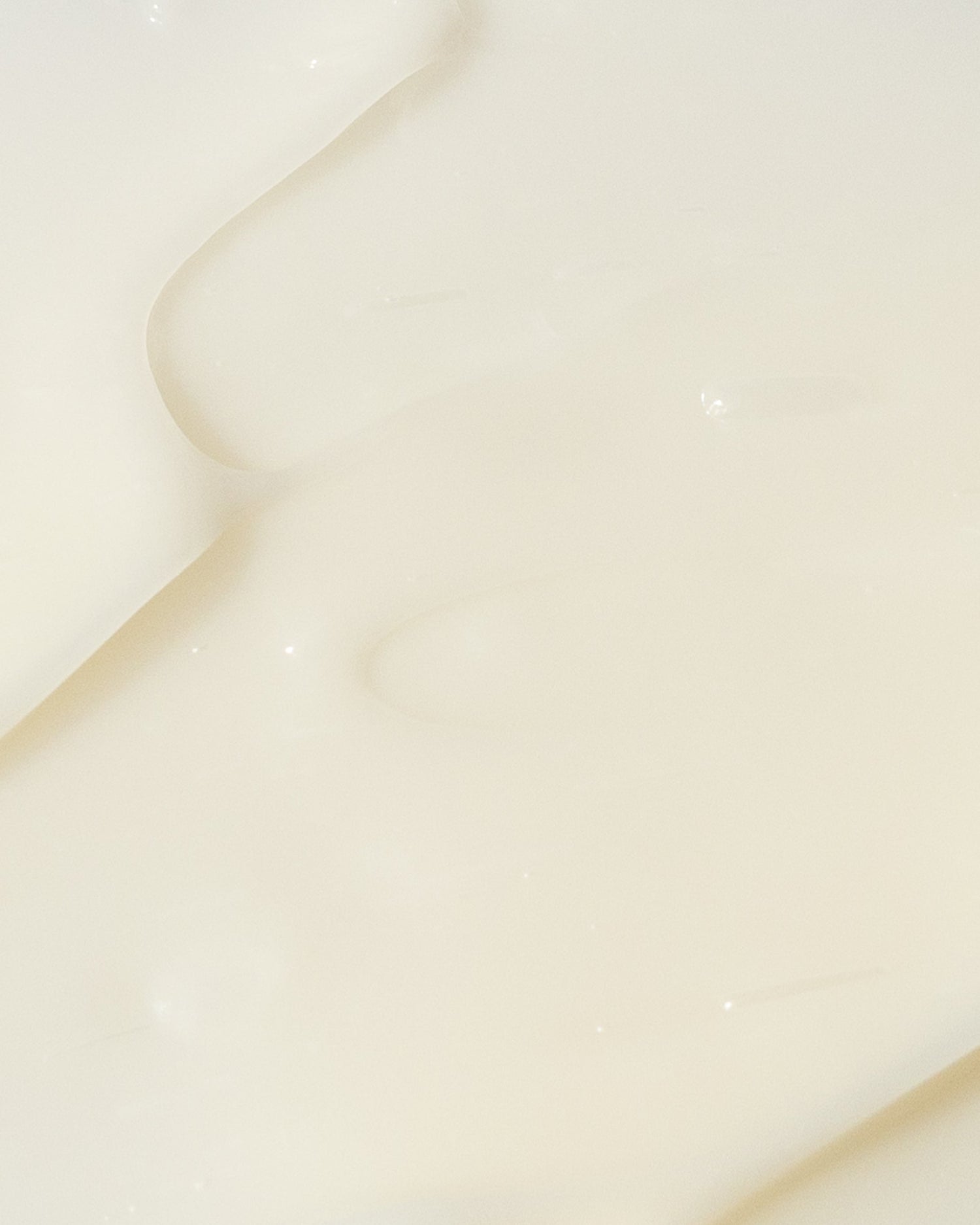 Close-up texture of AHA/BHA exfoliating cream with smooth, creamy consistency.