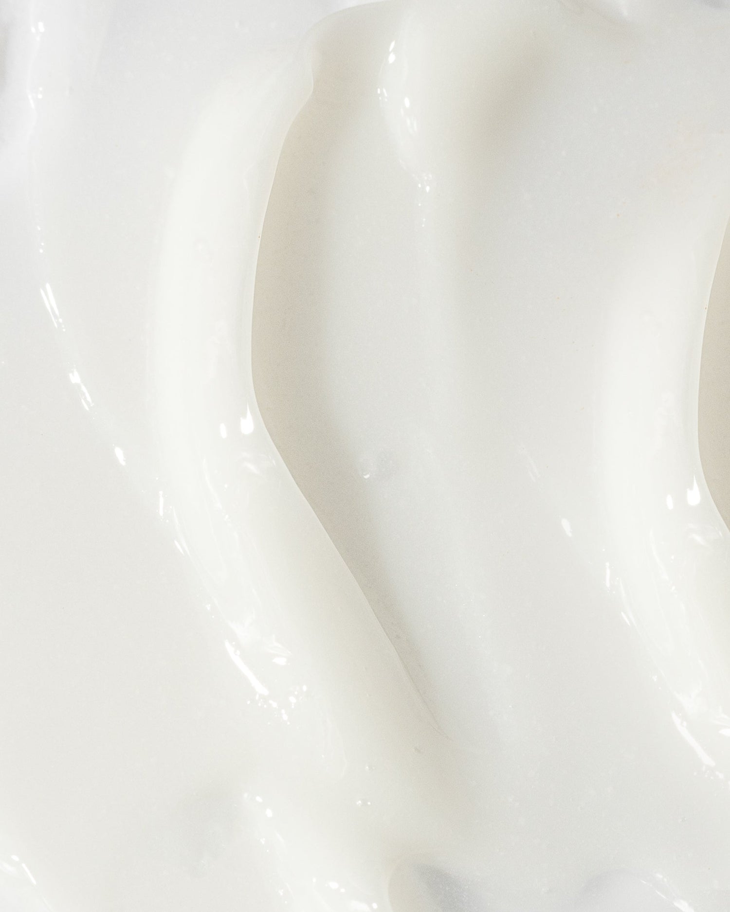 Close-up image of creamy white acne treatment lotion texture, highlighting its smooth and lightweight formulation for clear skin.