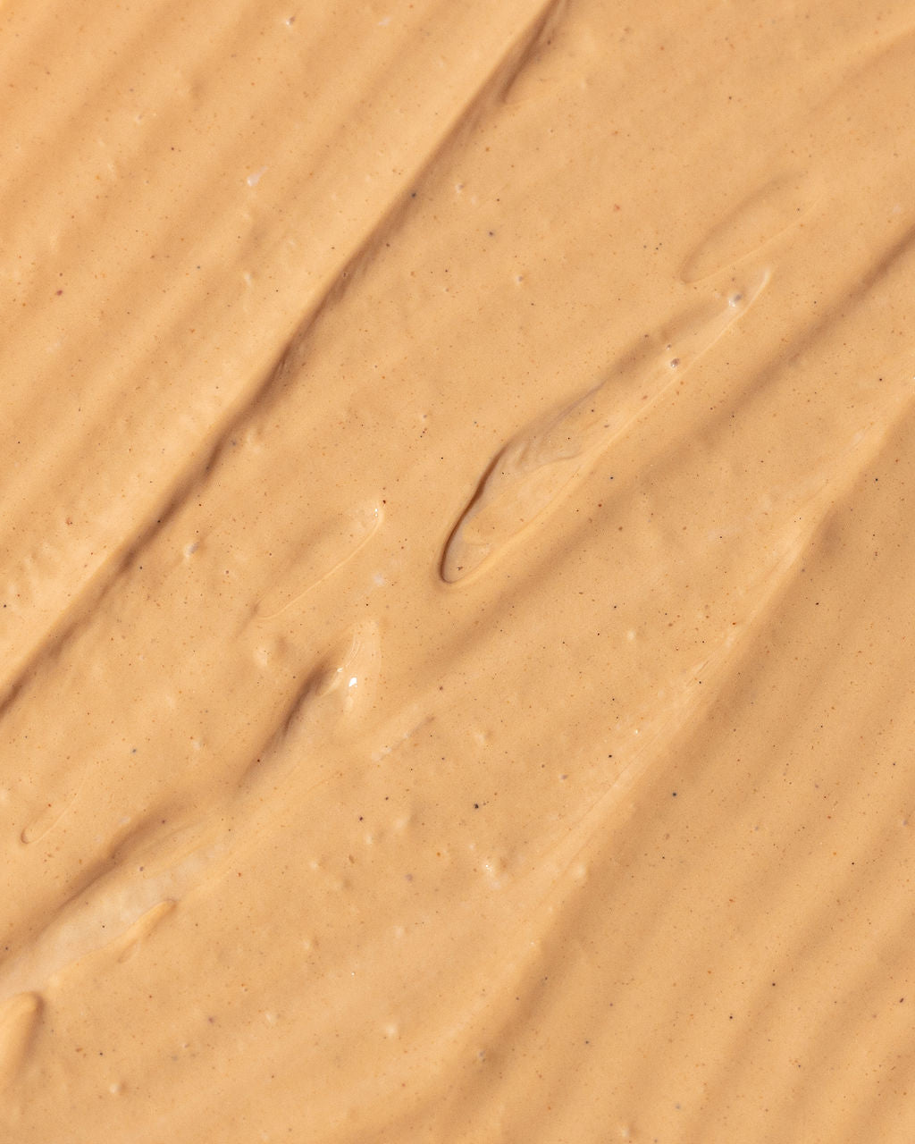 Close-up texture of Vivier Ultra Purifying Clay Mask with red and white Kaolin clay and AHAs for exfoliating and hydrating skin.