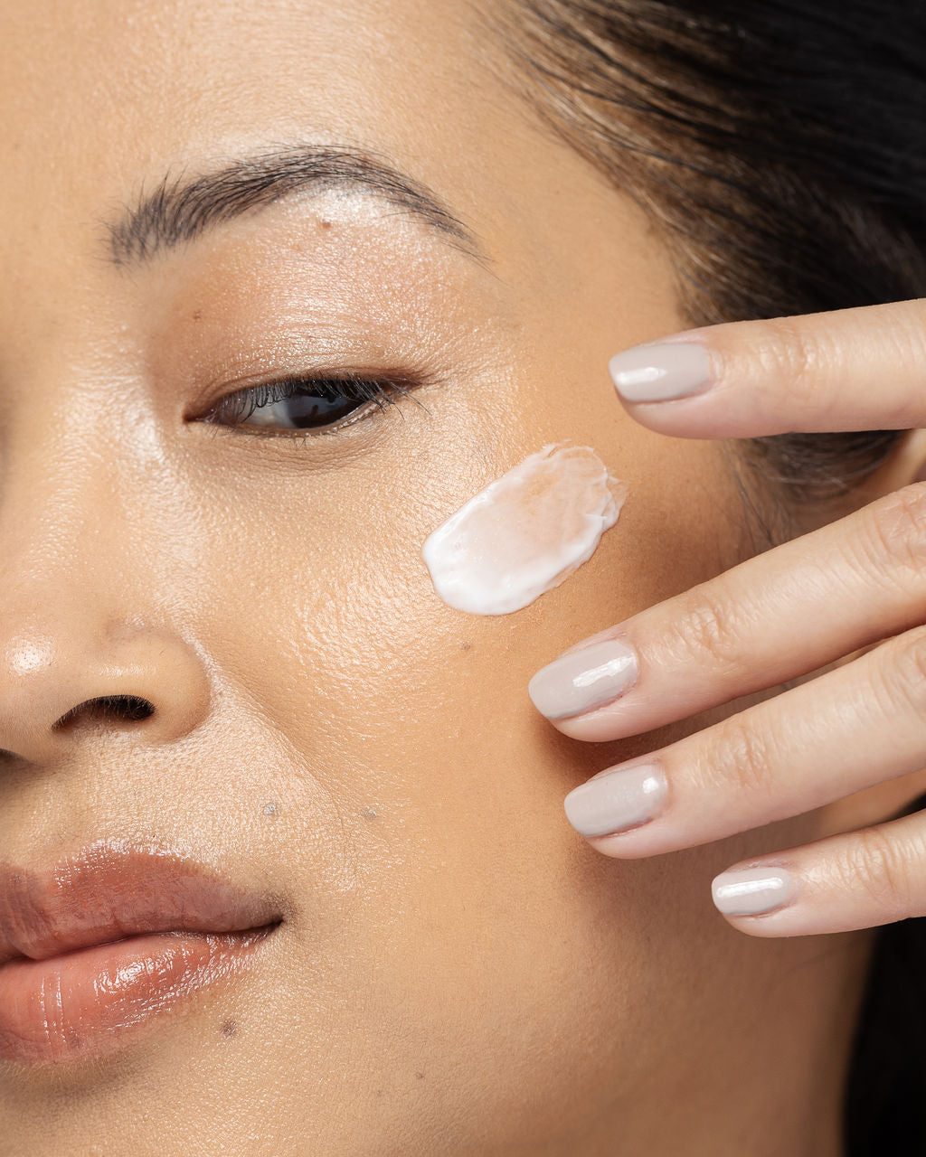 Model applying Vivier Daily Age-Defying Moisturizer on face for smooth, hydrated skin. Suitable for all skin types, non-comedogenic.