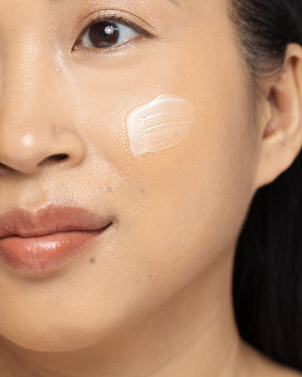 Close-up of a woman applying Vivier DERMA-V™ cream to her face, highlighting skin hydration and barrier repair benefits.