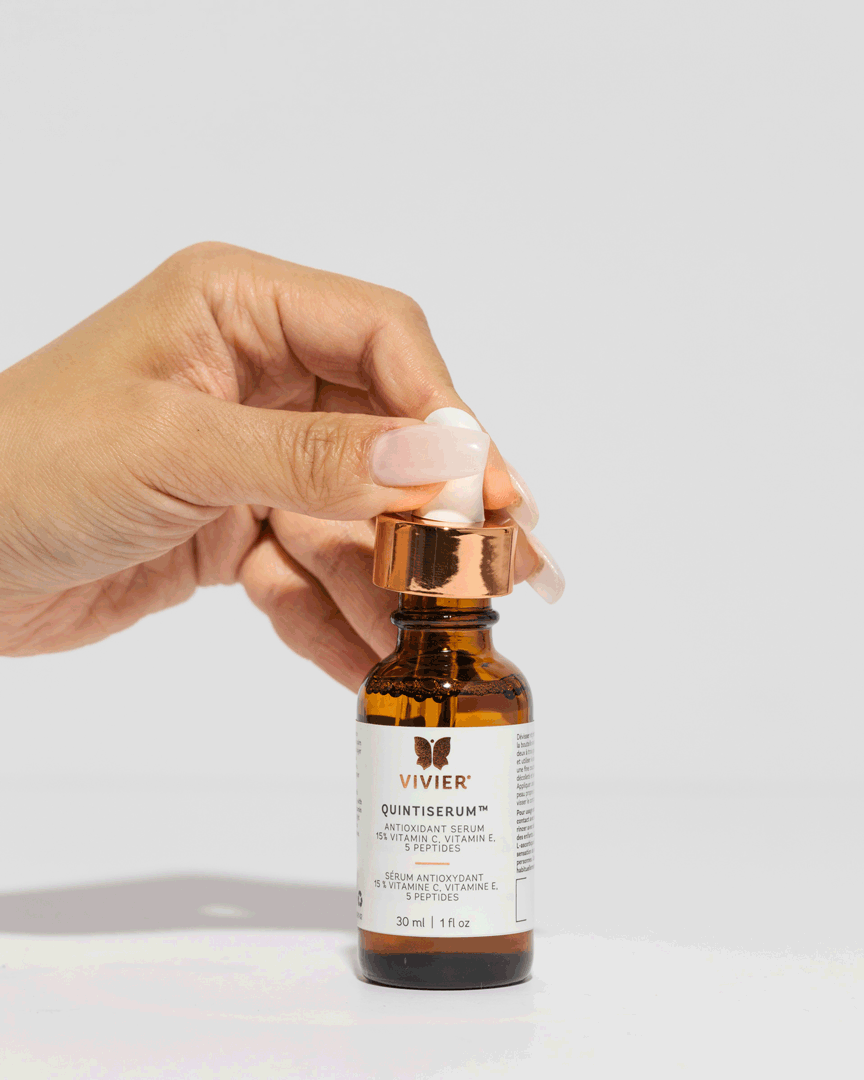 Hand holding Vivier QuintiSerum antioxidant serum with Vitamin C and peptides for anti-aging and collagen boost, 30ml bottle.