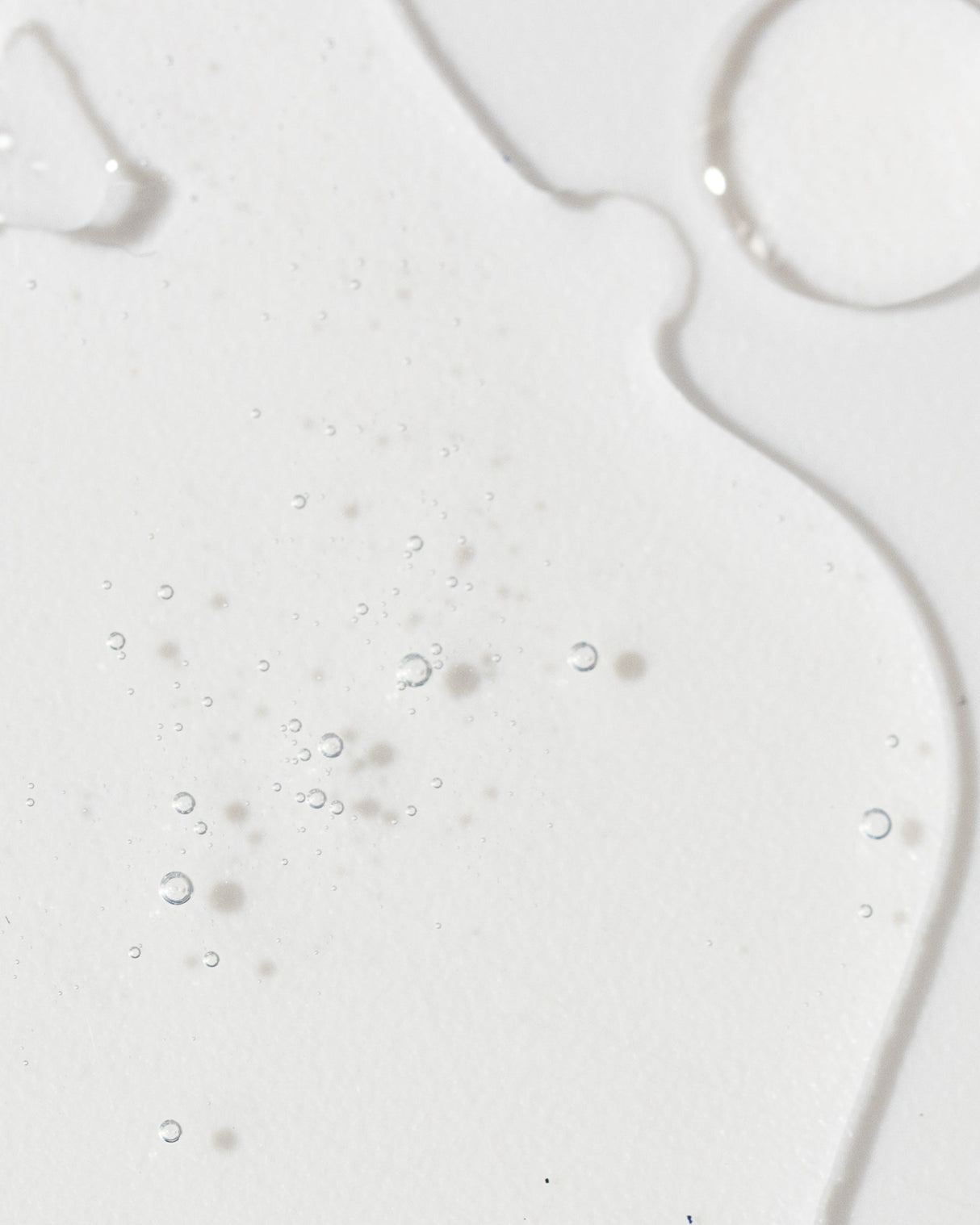Close-up of Vivier Radiance Serum texture showing light, liquid consistency with small bubbles.