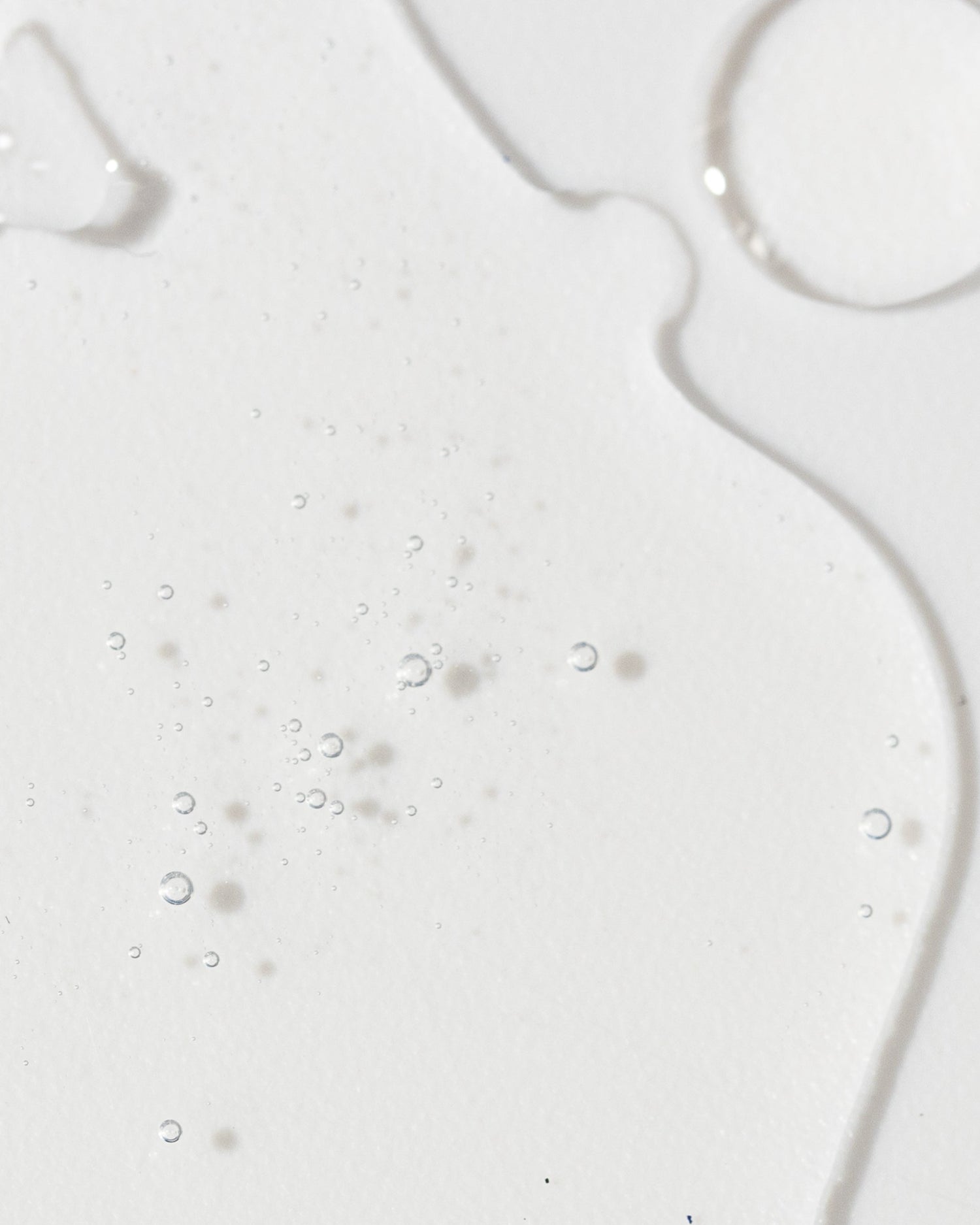 Close-up of Vivier Radiance Serum texture showing light, liquid consistency with small bubbles.