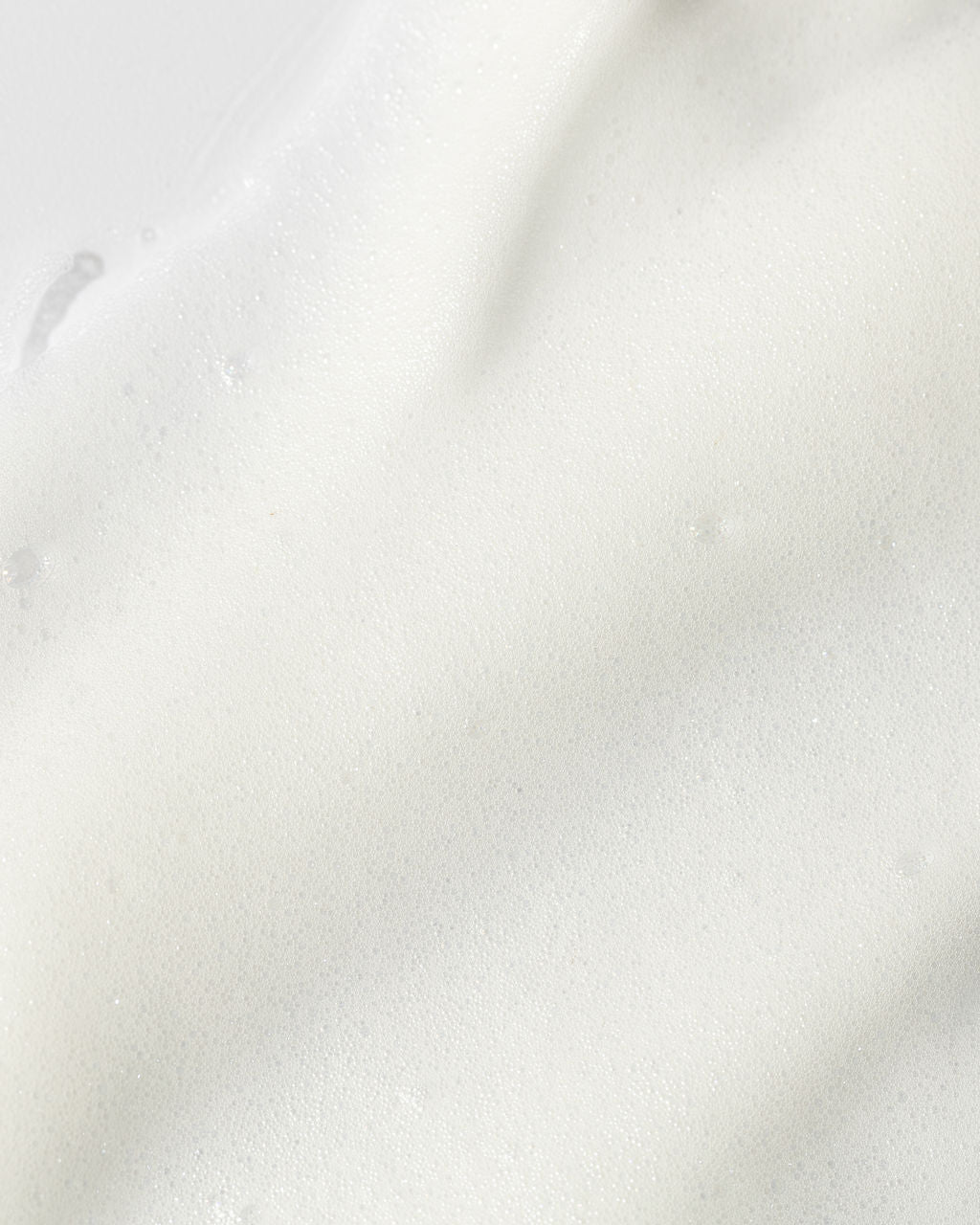 Close-up of Vivier Ultra Foaming Cleanser texture, showcasing its creamy, foamy consistency ideal for cleansing and hydrating the skin.