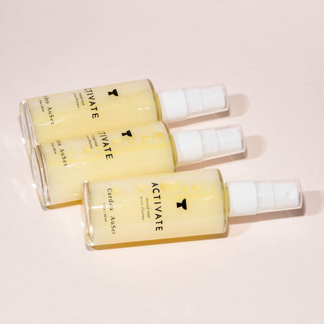 Three bottles of Activate Mood Mist aromatherapy spray with patchouli, lemongrass, and rosemary for natural energy boost.