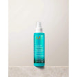 Moroccanoil All In One Leave-in Conditioner bottle on a table, offering hydration and thermal protection for all hair types.