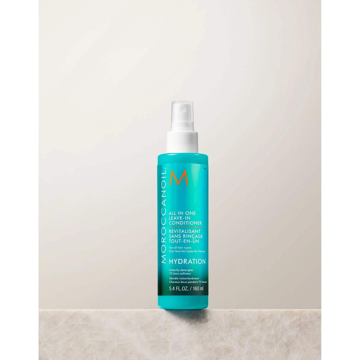 Moroccanoil All In One Leave-in Conditioner bottle on a table, offering hydration and thermal protection for all hair types.