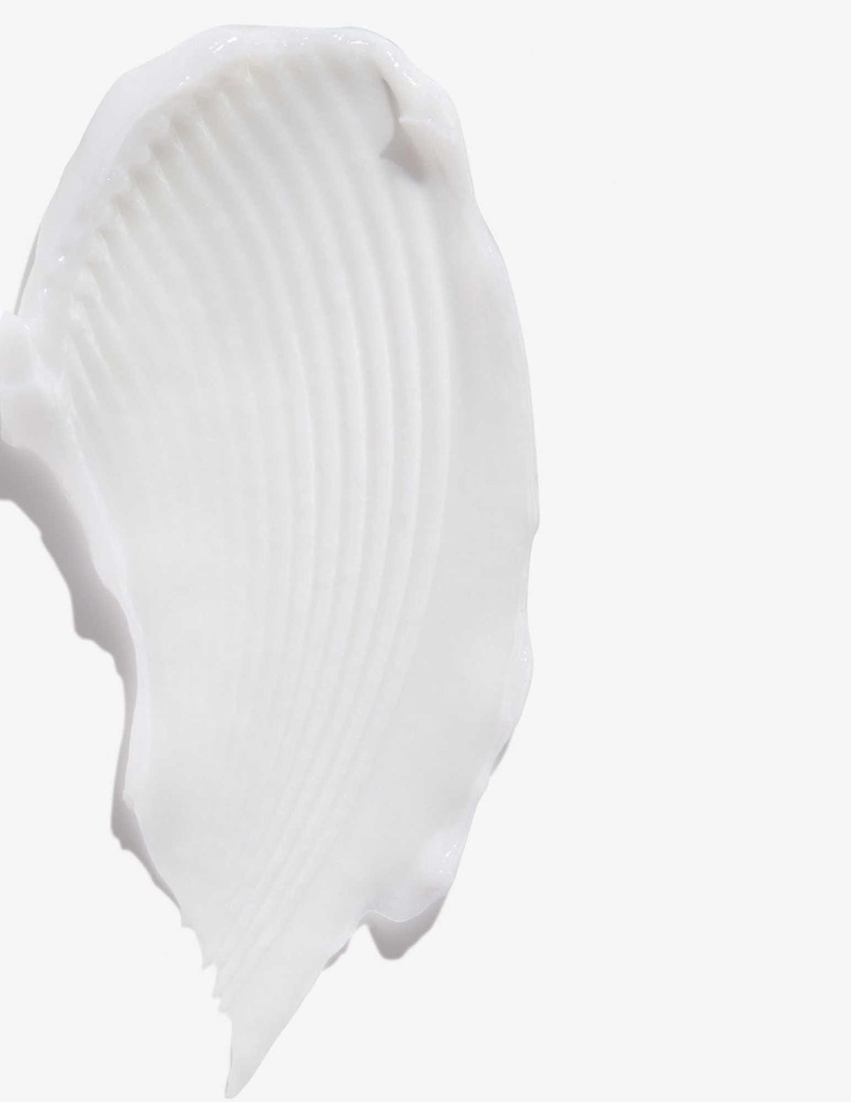 Close-up of a soft white cream texture from All Soft Conditioner, ideal for hydrating dry, brittle hair and reducing frizz.