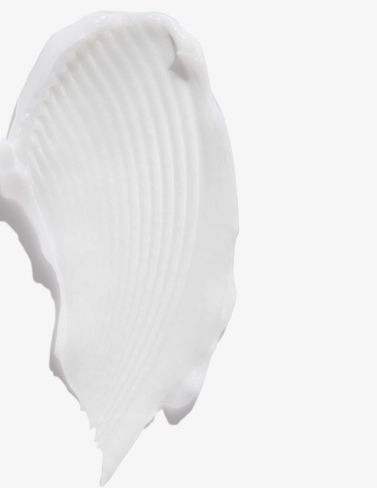 Close-up of a soft white cream texture from All Soft Conditioner, ideal for hydrating dry, brittle hair and reducing frizz.