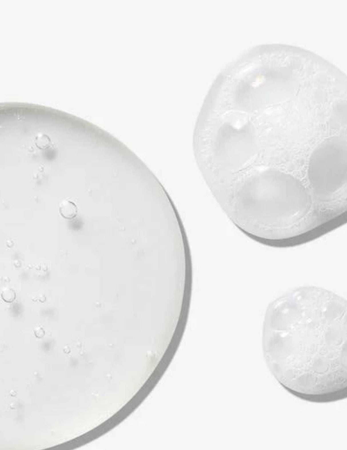 Texture of Redken All Soft Mega Curls Shampoo showing clear gel and frothy foam bubbles to highlight moisturizing qualities.