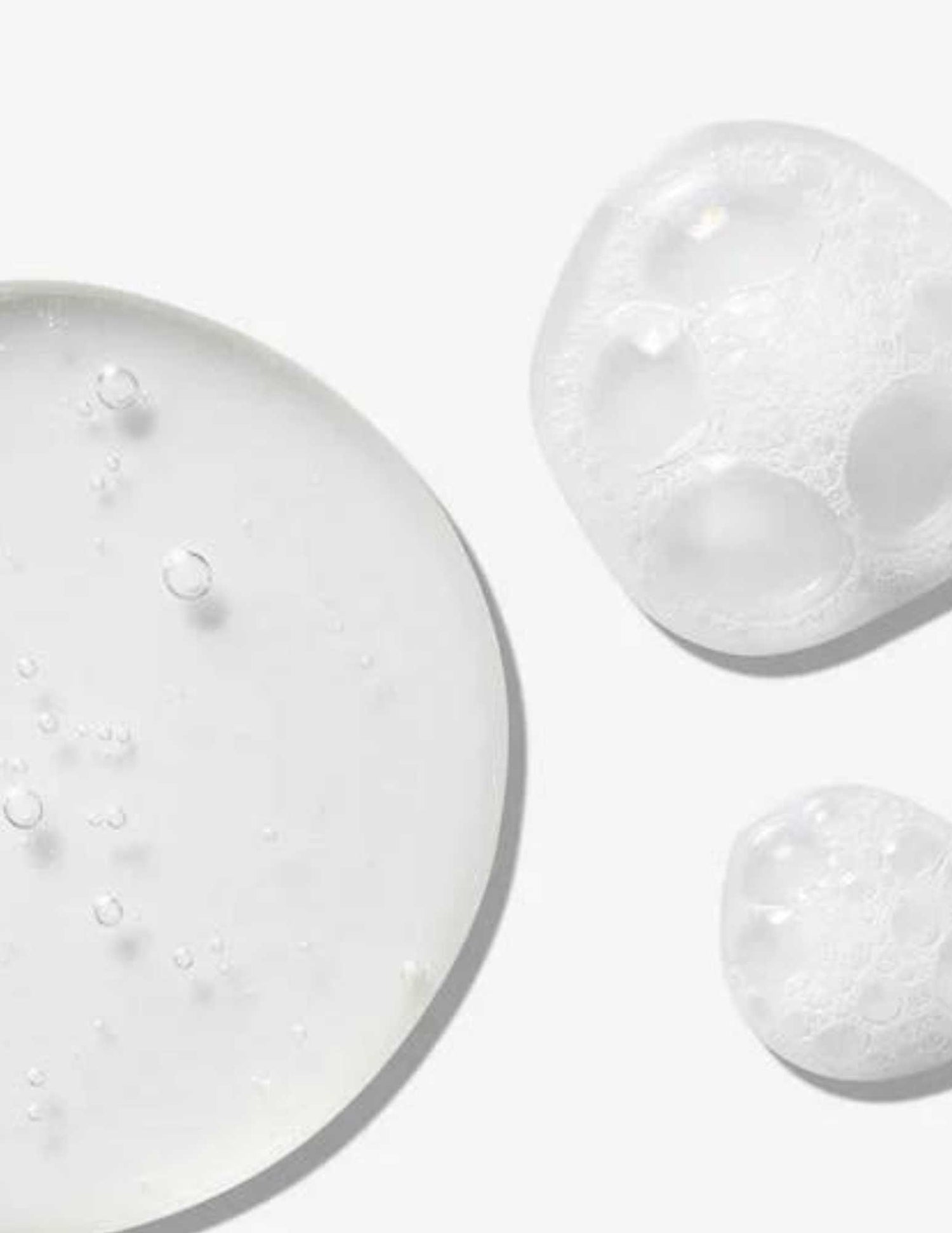 Texture of Redken All Soft Mega Curls Shampoo showing clear gel and frothy foam bubbles to highlight moisturizing qualities.