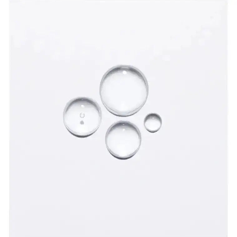 Clear liquid droplets showcasing texture of Kérastase Anti-Breakage Fortifying Treatment Ampoules for hair strengthening and protection.