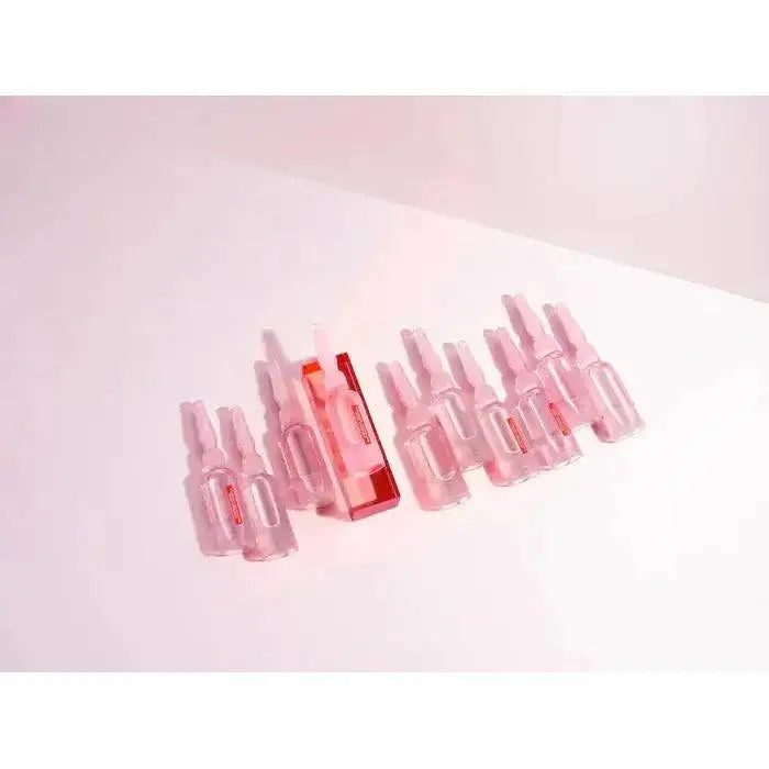 Kérastase Anti-Breakage Fortifying Treatment Ampoules for damaged hair showing pink ampoules on a light background.