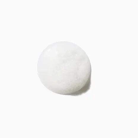 Round white shampoo lather from Kérastase Bain Prevention Shampoo, designed to help prevent hair loss and promote hair growth.