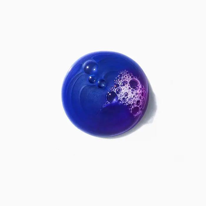 Purple Kerastase Bain Ultra-Violet shampoo swatch with bubbles on a white background, ideal for blonde, gray, and white hair.