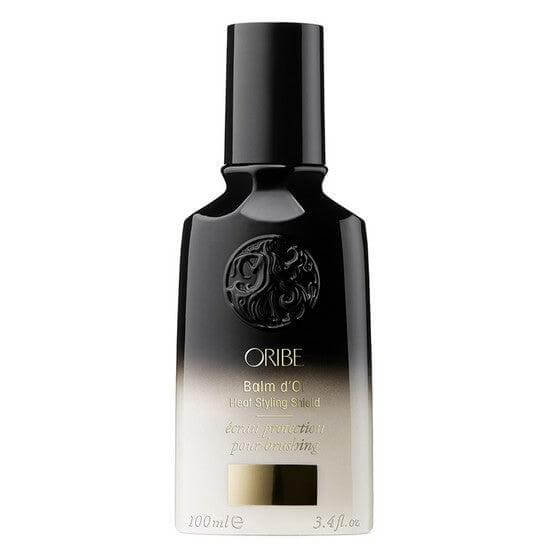 Oribe Balm D'Or Heat Styling Shield bottle for thermal hair protection and styling with heat tools.