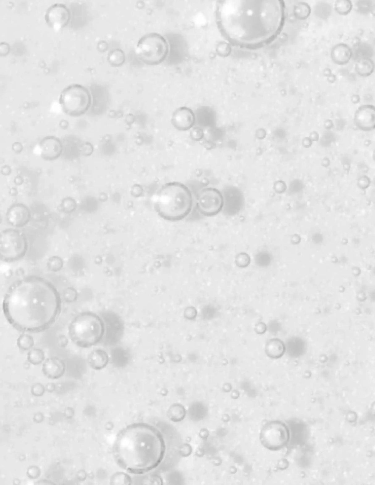 Close-up of clear liquid with bubbles, representing Redken Blondage High Bright Treatment for blonde hair.