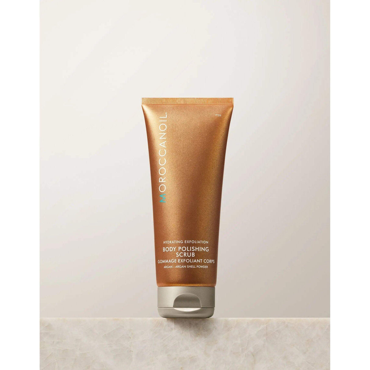 Moroccanoil Body Polishing Scrub Original tube with argan shell powder and six oils for smooth, radiant skin.