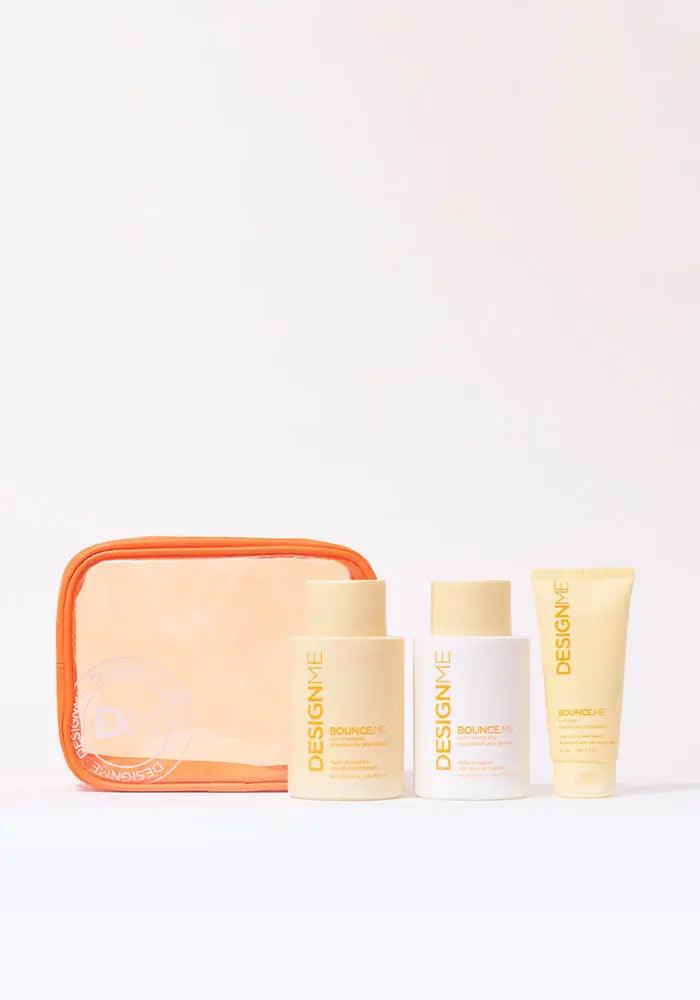BOUNCE.ME Curl Glitz Kit with shampoo, conditioner, and curl balm for wavy, curly, coily hair in orange travel pouch.