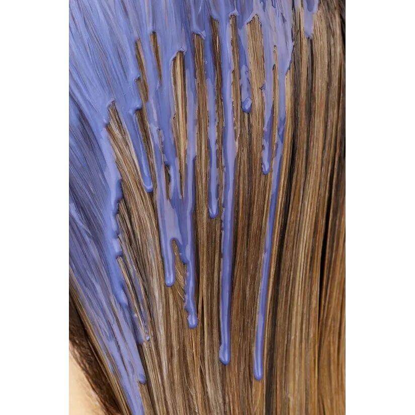 Bright blonde hair with violet treatment to repair damage and neutralize brassiness, showing vibrant color and shine.