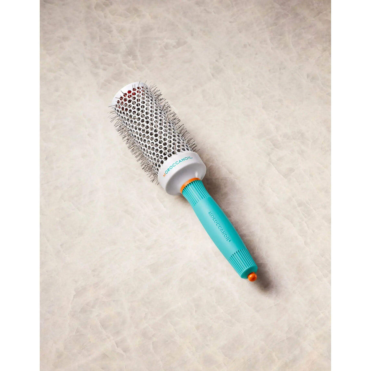 Ionic ceramic round hairbrush with retractable styling clip, teal handle, accelerates drying time and enhances styling.