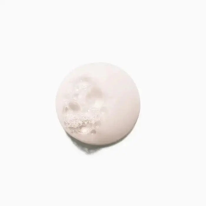 Close-up of foamy Chroma Absolu Bain Chroma Respect Shampoo for fine to medium color-treated hair on a white background