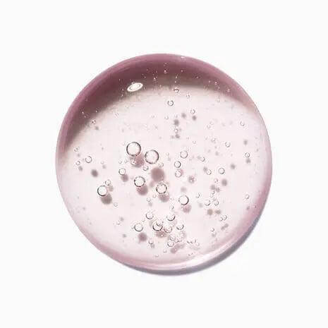 Close-up of Chroma Absolu Bain Riche Shampoo with bubbles, showcasing texture and pink hue, perfect for eco-friendly hair care.