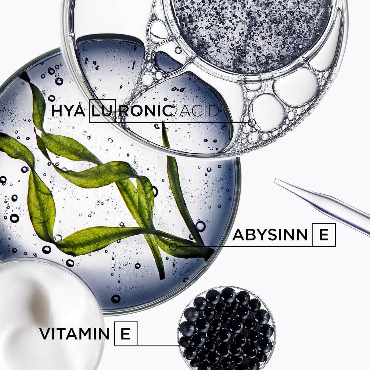 Ingredients in Kerastase hair oil: hyaluronic acid, abyssine, vitamin E displayed artistically in glass dishes