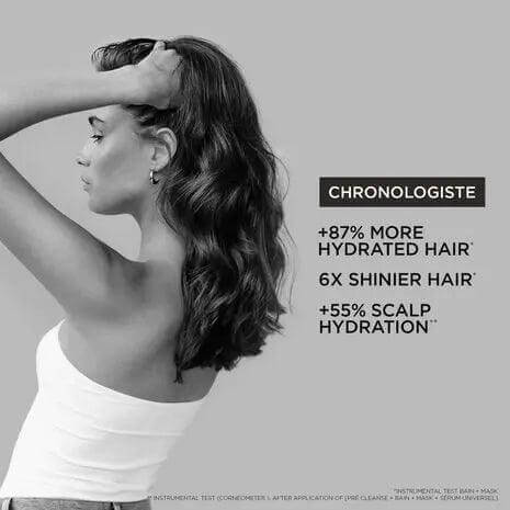Woman with long hair showcasing effects of Kérastase Chronologiste Serum, including increased hydration and shine benefits.