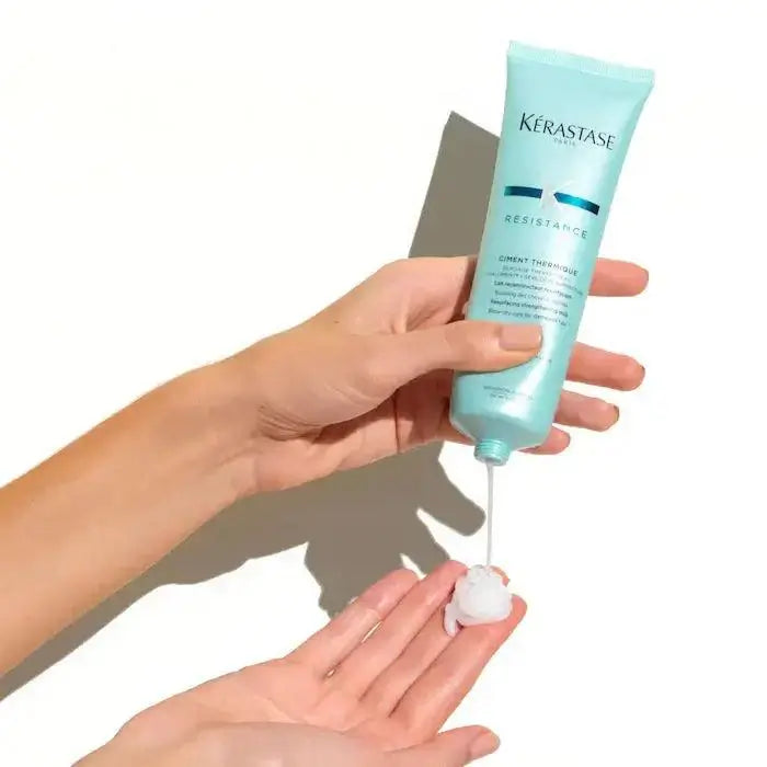Applying Ciment Thermique leave-in cream for heat protection and hair repair
